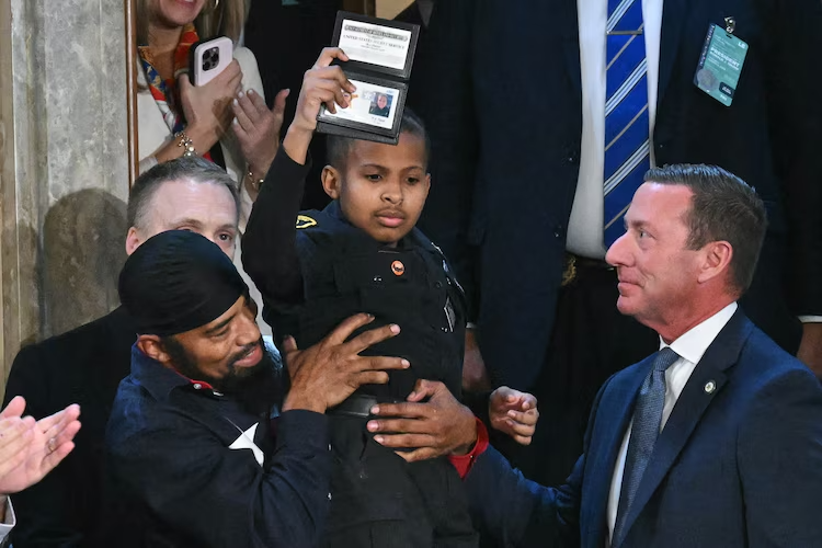 13-year-old cancer survivor Devarjaye "DJ" Daniel is lifted up by his father Theodis Daniel after President Donald Trump made him an honorary member of the US Secret Service at the US Capitol in Washington, Mar. 4, 2025.Saul Loeb/AFP via Getty Images